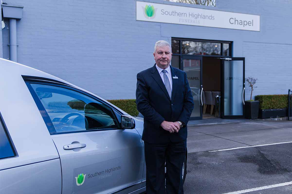 Southern Highlands Funerals Funeral Arranger at Entrance with Hearse